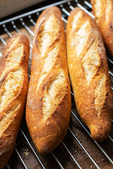 Batch of freshly baked baguettes background.