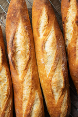 Batch of freshly baked baguettes background.
