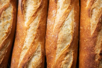 Fotobehang Batch of freshly baked baguettes background. © galiyahassan