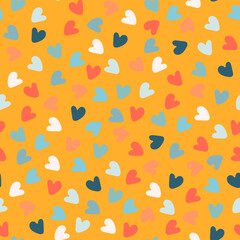 Seamless pattern with hand drawn multicolored heart shapes on orange background, for wrapping paper and other design projects. Valentines Day concept, love, romance concept