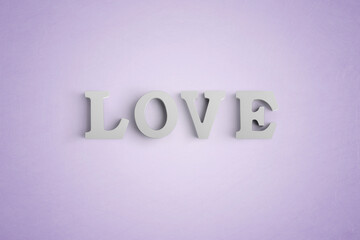 Wooden letters spelling LOVE with a heart shaped white balloon