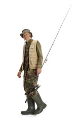 Portrait of young man, professional fishman with fishing rod, spinning and equipment going to river isolated over white studio background