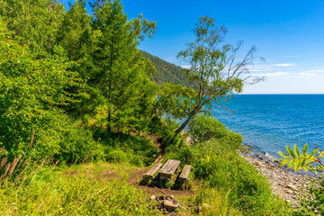 Great Baikal Trail. Route along lake Baikal shore from Listvyanka to Big Koty. Place to relax, wooden table with bench near lake Baikal. Summer travel, discovery of beauty of Earth. Siberia, Russia © Tatyana_Andreyeva