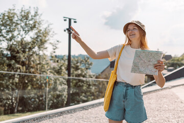 Happy caucasian  woman in hat with map in urban city park, freedom and active lifestyle