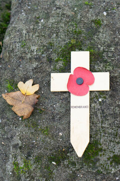 Lest we forget - Remembrance poppy on a wooden cross symbol of the first World War WOI at old trenches near Ypres Belgium