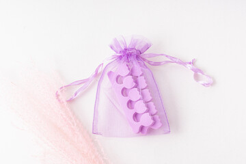Purple toe dividers in pouch. Tool for pedicure. Soft styrofoam. Travel kit
