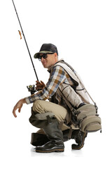Portrait of young man, professional fisherman with fishing rod, spinning and equipment sitting...