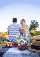 couple in love drinking wine on a picnic. Selective focus