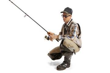 Portrait of young man, professional fisherman with fishing rod, spinning and equipment going to river isolated over white studio background