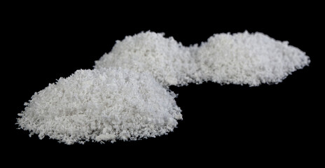 A pile of white snow isolated on a black background