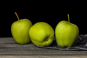 Green apples isolated on black background.