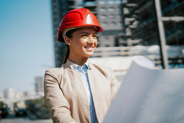 Young beautiful architect. Female engineer with her equipment. Businesswoman working on the new project