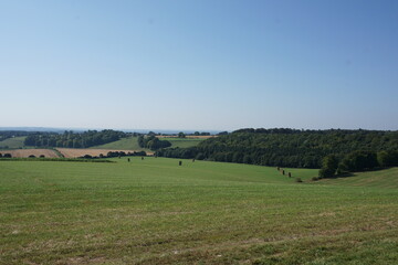 Fototapeta na wymiar view over rolling farm fields. English countryside view on clear day over agricultural farmland. 