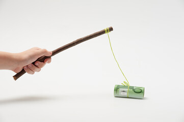 The concept of fishing with money on a hook as bait or incentive.