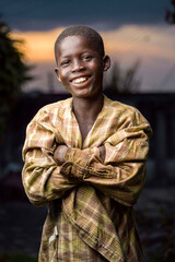 image of cheerful african boy with a folded arm- outdoor portrait concept