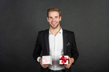 happy elegant guy in businesslike suit hold valentines day gift, be my valentine