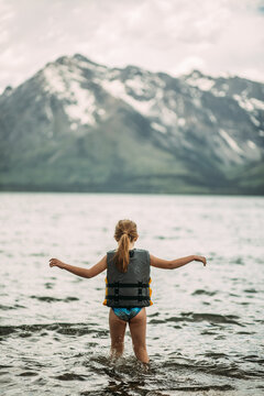 Young girl playing in Jackson Lake  in Grand Teton National Park