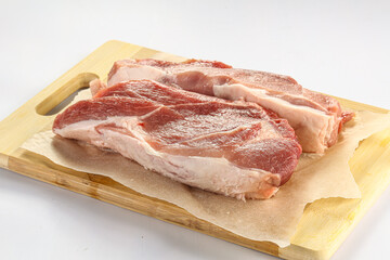 Raw pork fillet over board