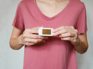 Woman using oximeter
