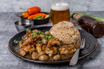 tenderloin cubes sautéed in soy sauce onion tomato coriander with French fries and rice on gray marble