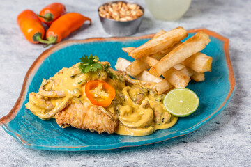 mix of seafood with cassava corn mote and lemon on gray marble