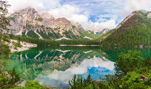 Lake lago di braies panorama in a foggy morning with glaciers mountain and reflection in dolomite alp, Italy