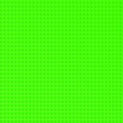 Green plastic constructor blocks plate. Abstract background