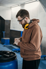 The man reloads his weapon before shooting at the target.