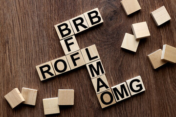 BFF, ROFL, OMG and LMAO, BRB .Be Right Back. cut text messages on wooden cubes in the form of a...