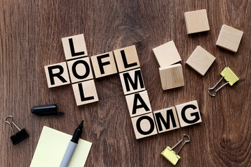 LOL Laugh out loud, LMAO, ROFL, OMG, text message abbreviation on wooden cubes in the form of a...