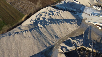 aerial view of sand dunes within the factory for the production of concrete and asphalt for roads,...