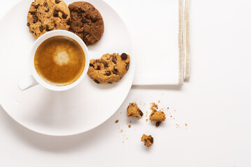  Cup of coffee with milk and chocolate cookie on white background. Top view. Copy space.