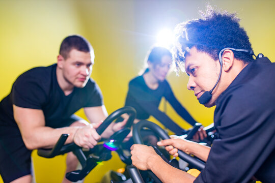multicultural groyp of happy young strong people cycling In class while keeping social distance covid corona virus immunity