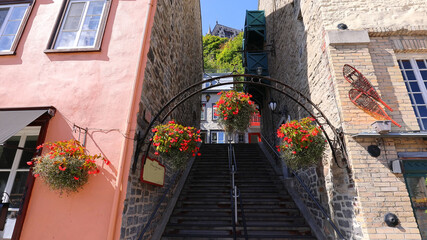 Low angle view of Old Quebec City tourist attractions of Quartier Petit Champlain lower town, shopping district and old French architecture.