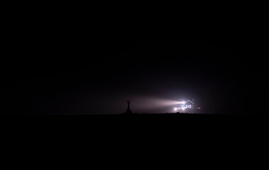 ferry and lighthouse at night
