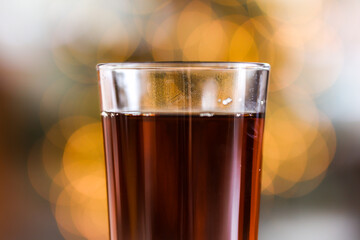Close-up of Black Tea in Transparent Class with Magical Bokeh Background. Shallow Depth of Field of Hot Beverage.
