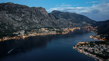 Photo of sunset in the Boko Kotor Bay, night city lights