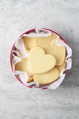 Shortbread cookies in shape of heart in red box on grey background. Mother's day, Women's day, Valentine's Day. Homemade present.