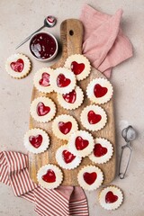 Linzer cookies in shape of heart with jam on wooden board. Mother's day, Women's day, Valentine's day. Homemade present.