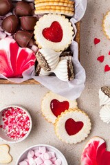 Valentines Day sweets and cookies in wooden box. Chocolate, candy, meringue, marshmallow, linzer cookies, gingerbread. Mother's day, Women's day. Homemade present.
