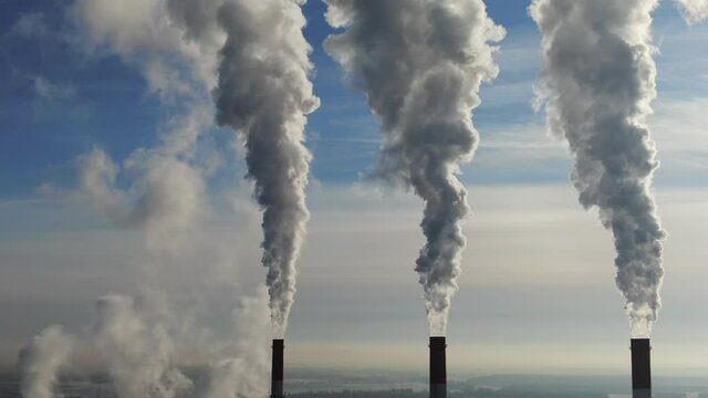 Industrial pipes and puffs of smoke. Power station. Environmental pollution. Bad ecology. Air pollution. Global warming. Atmosphere system. Smoke in the air. Smog.