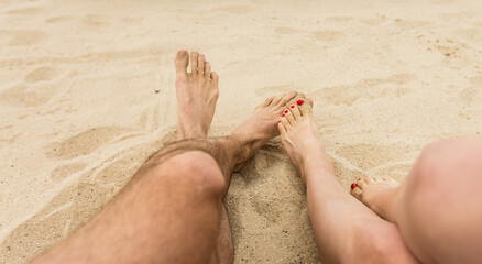 Closeup of feet row lying in line at summer beach