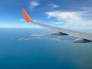 Wing of an airplane flying above the ocean in Brazil.