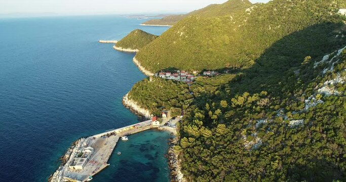Aerial view of a small pier for ferry along the coast facing the Adriatic Sea near Lastovo, Croatia.