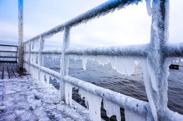 Icicles hanging on footbridge - frost, winter concept