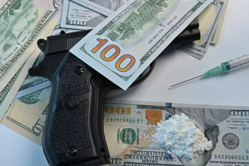 Cocaine flour on dollar banknote. Black gun for drug dealing protection. Syringe for abuse cocaine...