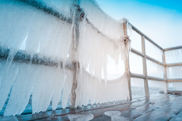 Icicles hanging on footbridge - frost, winter concept