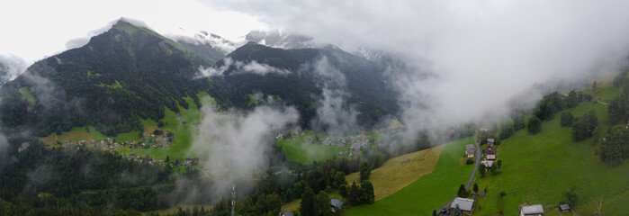 Panoramic view on mountain villages, green forests and apline meadows near Saint-Gervais-les-Bains, Savoy. France