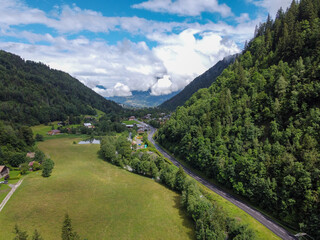 Panoramic view on green Alpine spruce and pine tree forests and meadows near Saint-Gervais-les-Bains, Savoy. France