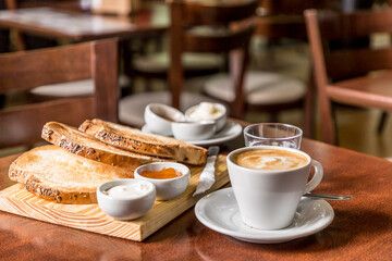breakfast of toast with jam with coffee on wood
